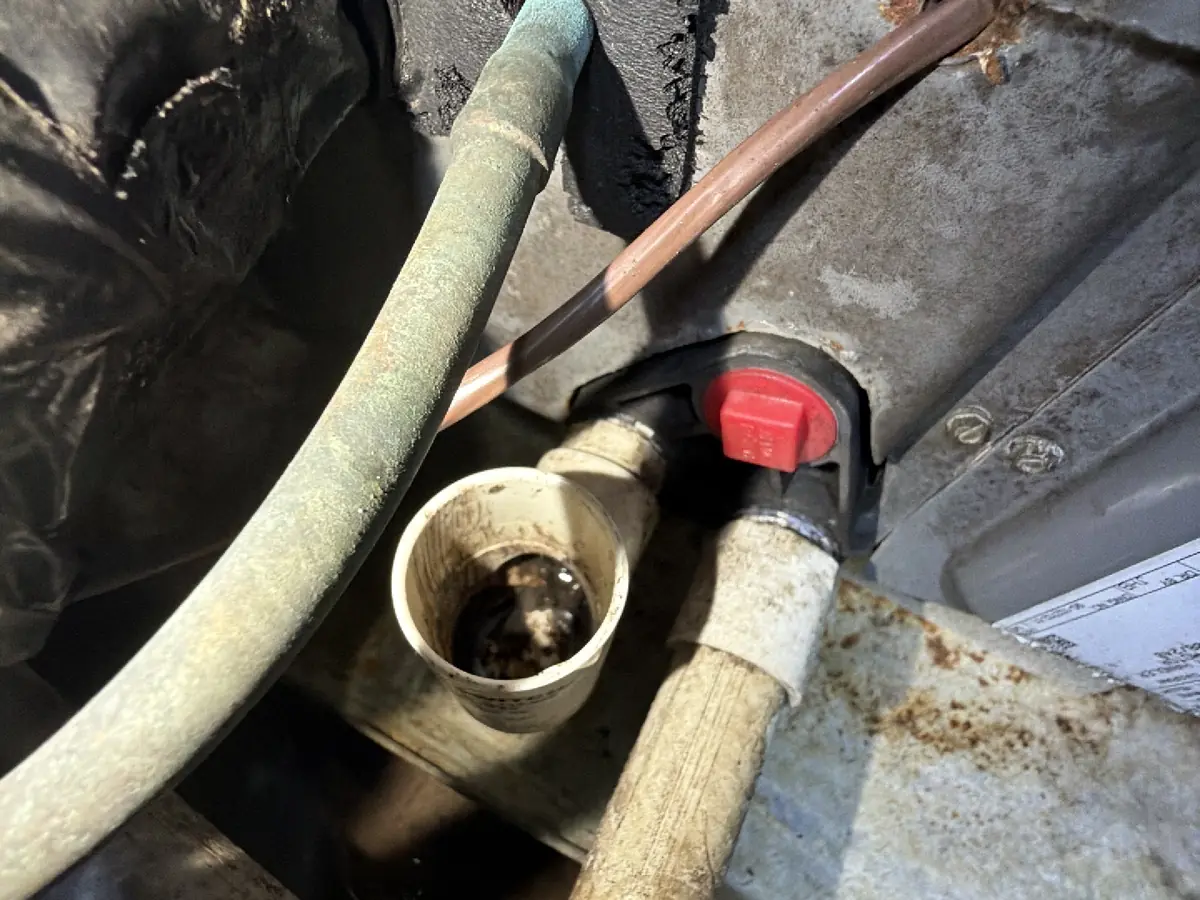 Corroded refrigerant line and condensate drain on an aging Florida air handler