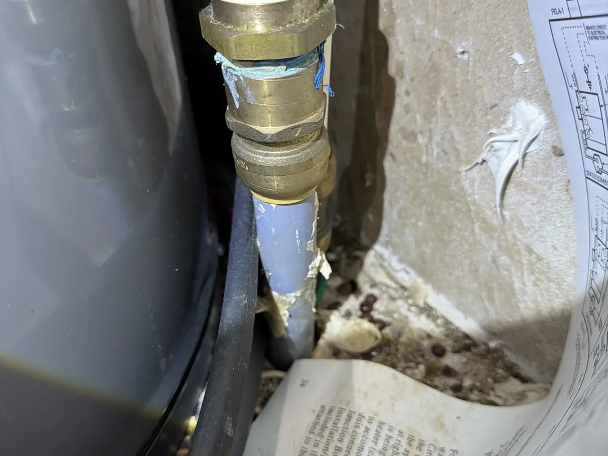Polybutylene supply line and push-fit fittings at a water heater, a common 4-point inspection finding
